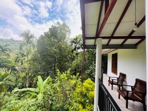 a balcony of a house with two benches on it at Madiriya Forest Lodge Apartment in Badulla
