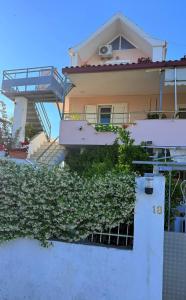 a house with ivy growing up the side of it at Priam Garden in Durrës