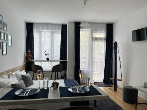 a living room with a couch and a table with chairs at Apartment for rest in Borovets in Borovets