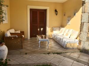 a living room with a couch and a coffee table at Luxury apartment Erica sea view with common swimming pool just 10 mt from the beach in Golfo Aranci