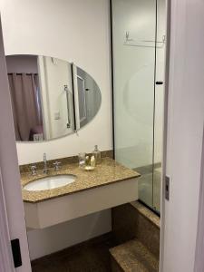 a bathroom with a sink and a mirror at Plaza Inn - Brasília Small Town 32 in Sao Paulo