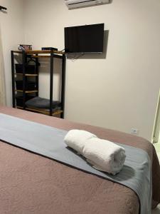 a bedroom with a bed with a towel on it at Plaza Inn - Brasília Small Town 32 in Sao Paulo +20 photos