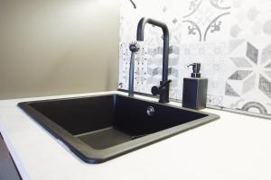 a kitchen sink with two faucets on a counter at Germany's Ferienwohnung in Kaiserslautern