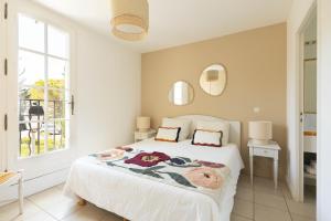 a bedroom with a bed and two mirrors on the wall at Villa Les Mimosas, Fayence in Fayence +20 photos