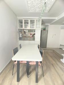 a white table and chairs in a room at Modern & Spacious 2BR- Ville Haute Kenitra-Garage in Kenitra