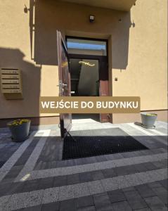 a door to a building with a sign that reads westisse do bubble kuv at Perłowy in Biłgoraj +2 photos