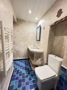a bathroom with a toilet and a sink at Western Wall Essaouira in Essaouira