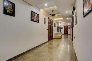 a hallway with white walls and a hall with a door at Hotel O Golden Eye Inn in New Delhi
