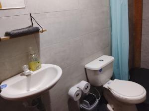 a bathroom with a white toilet and a sink at Cabaña El Cangrejo Azul - Blue Crab House in San Onofre +23 photos
