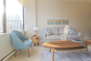 a living room with a couch and a table and a chair at Beautiful Downtown Unit in Vancouver