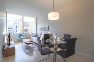a living room with a table and a couch at Beautiful Downtown Unit in Vancouver