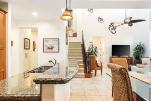 a kitchen and living room with a counter top at Big Island Fairways at Mauna Lani 1701 by Coldwell Banker Island Vacations in Waikoloa