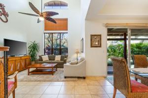 a living room with a couch and a table at Big Island Fairways at Mauna Lani 1701 by Coldwell Banker Island Vacations in Waikoloa