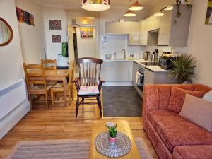 a living room with a couch and a table at Historic Gloucester Stay - A Hidden Gem in Gloucester