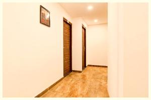 an empty hallway with white walls and wooden floors at MUSSOORIE HOTEL UPHAR PALACE Near The Mall Road And Temple - A Premium Hotel IN Mussoorie in Mussoorie