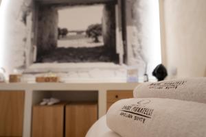 Łóżko lub łóżka w pokoju w obiekcie Dimore Pignatelli Apulian Suite