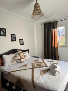 a bedroom with a bed with towels on it at Riad Four Rooms & Pool in Marrakesh