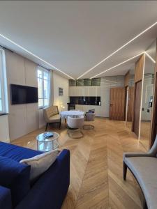 a living room with a blue couch and a table at LUXE-POLE Appartement à 100m de Monaco in Cap d'Ail
