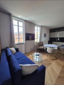 a living room with a blue couch and a table at LUXE-POLE Appartement à 100m de Monaco in Cap d'Ail +7 photos
