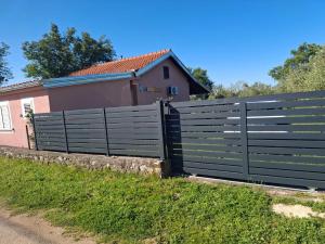 a fence in front of a house at In the nature by Marko in Benkovac +6 photos