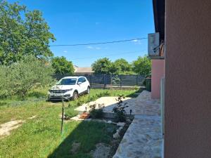 a white car parked in a yard next to a house at In the nature by Marko in Benkovac