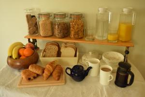 a shelf filled with different types of bread and other foods at Bed & Breakfast at Newton House Farm in Sneaton