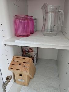 a shelf with a vase and a box on it at Allan & Ella House in Perth