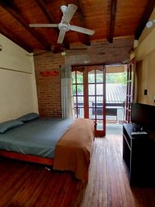 a bedroom with a bed and a ceiling fan at Cabañas Costa Santino in Ituzaingó +65 photos