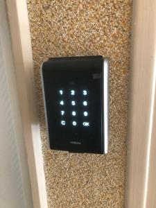 a black push button remote control on a wall at Villa Jean Pierre in Pougues-les-Eaux