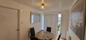 a dining room with a table and chairs and a window at Detached 3 Bedroom House in Leicester with Private Parking in Leicester