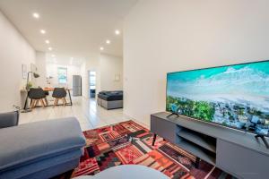 a living room with a large flat screen tv at XXL Design-Appartement Hidesign 8 P Heidelberg Mannheim in Weinheim