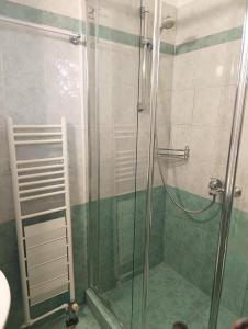 a shower with a glass door in a bathroom at P studios in Sami