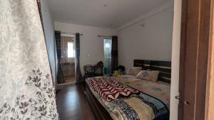 a bedroom with a large bed in a room at Quarali Homestay in Mukteswar +27 photos