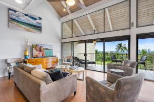 a living room with two couches and a tv at Big Island Keauhou Punahele A301 by Coldwell Banker Island Vacations in Kailua-Kona
