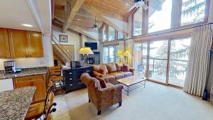 a living room with a couch and a table at Crestwood 3302 Deluxe 1 Bedroom Plus Loft in Snowmass Village
