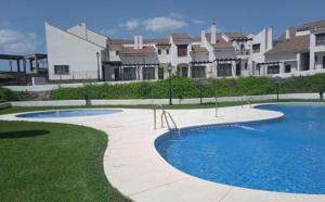a large swimming pool in front of some buildings at Casa rural La Abuela in El Ronquillo