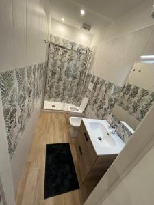 a bathroom with a sink and a toilet at A due passi dal mare in Barletta +10 photos