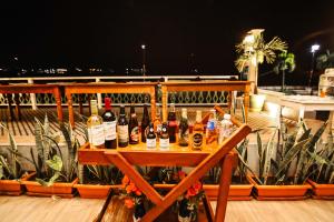 a table with bottles of wine on a balcony at Hotel Petén Express in Flores