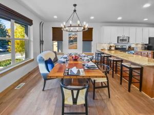 a dining room and kitchen with a table and chairs at 5410 Cross Country Mountain Ski Getaway with Hot Tub Pool! by SkyRun Park City in Park City