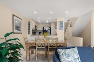 a dining room and kitchen with a table and chairs at QA4 Coastal Comfort in Nags Head