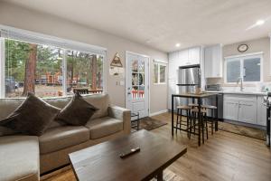 a living room with a couch and a table at The Maple Lane Hideaway - Hot Tub, Fireplace, Barbecue, Fenced Yard! in Sugarloaf