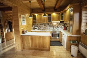 a kitchen with wooden cabinets and a white counter top at Chata Čučoriedka Litmanová in Litmanová