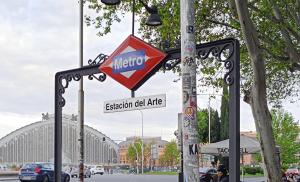 a metro sign on a pole in a street at CH Las Artes de Atocha in Madrid