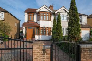 a house with a black fence in front of it at Spacious 3 bedroom, 3 bathroom house in Enfield