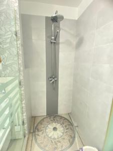 a bathroom with a shower with a drain in the floor at Modern & Spacious 2BR- Ville Haute Kenitra-Garage in Kenitra
