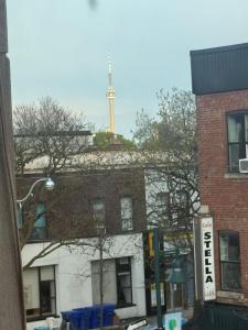 a tower on top of a brick building with a building at Maple Leaf Stay-Walk to UOFT,DT,STREET CARS,BARS,ROM-Free Wifi in Toronto +22 photos