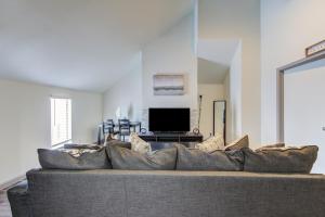 a large couch in a living room with a television at Cozy 2BR 2BA Condo in Houston Medical Center Free Parking & Fast Wi-Fi in Houston