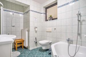 a bathroom with a tub and a toilet and a sink at Resort pod orehi - Bled - Apartma & Glamping & Savna in Bled