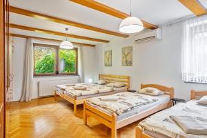 una camera da letto con tre letti e una finestra di Resort pod orehi - Bled - Apartma & Glamping & Savna a Bled
