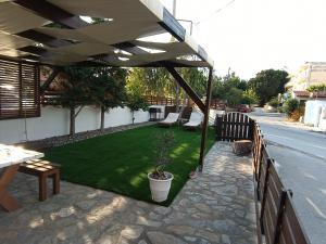 a patio with a table and chairs under a canopy at Sofia-Irini in Kalamaki Heraklion